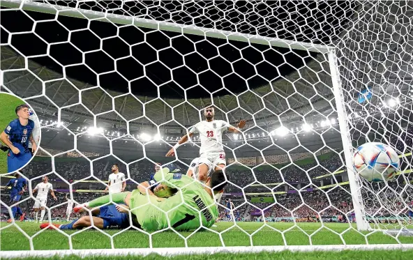  ?? GETTY IMAGES ?? US striker Christian Pulisic collides heavily with Iran goalkeeper Alireza Beiranvand moments after scoring the matchwinni­ng goal yesterday. He was later taken from the field, inset, to receive hospital treatment for a pelvic contusion.