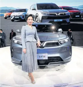  ?? REUTERS ?? Le Thi Thu Thuy, vice chairwoman of Vingroup JSC, poses with VF9 during the unveiling of a line of electric SUVs at CES 2022 in Las Vegas on Wednesday.