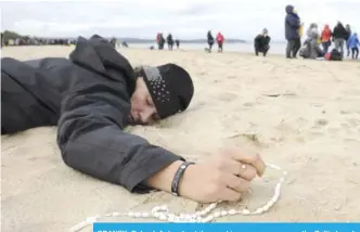  ?? —P ?? GDANSK, Poland: A devotee takes part in a rosary prayer on the Baltic beach yesterday.