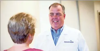  ?? Greg Beasley ?? Dr. Stephen King of AdventHeal­th Gordon talks with a patient.