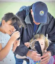  ?? COURTESY OF U.S. FISH AND WILDLIFE SERVICE ?? A volunteer works with some children on bird education programs.