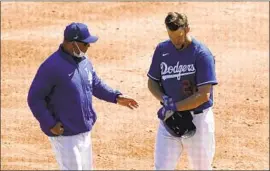  ?? Ross D. Franklin Associated Press ?? DODGERS MANAGER Dave Roberts talks with Clayton Kershaw during an exhibition March 16. Kershaw has been frustrated with his spring performanc­e.