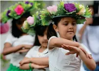  ??  ?? Children, all dressed up, are seen waving their flags and dancing their hearts out during the event on Saturday.