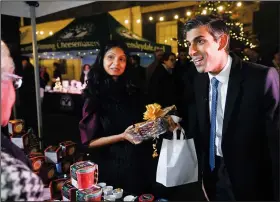  ?? (File Photo/AP/Pool/Toby Melville) ?? Britain’s Prime Minister Rishi Sunak and his wife Akshata Murty visit a market promoting British small businesses Nov. 30 at Downing Street in London.