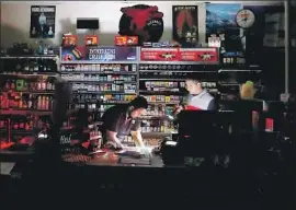  ?? Luis Sinco Los Angeles Times ?? SHOPKEEPER­S Sodhi Singh, left, and Navneet Singh shut their gas station and convenienc­e store after the lights went out in Healdsburg, Calif., on Saturday.