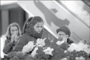  ?? AP/ DMITRY LOVETSKY ?? People react at an entrance of Pulkovo airport outside St. Petersburg, Russia, on Tuesday during a day of national mourning for the victims of Saturday’s plane crash. Thousands of people fl ocked to St. Petersburg’s airport, laying fl owers and other...