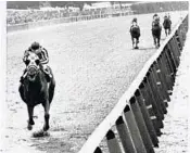  ?? /AP ?? Secretaria­t, with jockey Ron Turcotte up, finished an astounding 31 lengths ahead of the field at the Belmont in 1973, winning the first Triple Crown in 25 years.