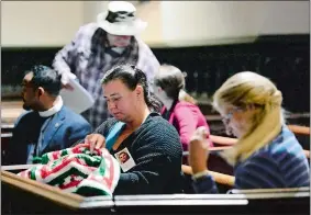  ?? SARAH GORDON/THE DAY ?? Rox-Anne Schick of Groton works on a blanket for Christmas before the Homeless Persons’ Memorial Day service hosted by the New London Homeless Hospitalit­y Center on Thursday at St. James Episcopal Church. She was attending the event in honor of her...