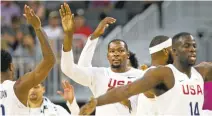  ?? L.E. BASKOW/ASSOCIATED PRESS ?? Kevin Durant, center, greets teammates as they come off the court during a timeout in an exhibition game against Argentina on Friday.