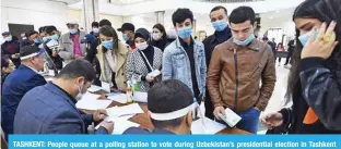  ?? ?? TASHKENT: People queue at a polling station to vote during Uzbekistan’s presidenti­al election in Tashkent yesterday. — AFP