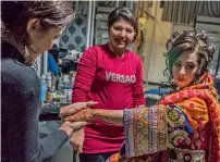  ?? AFP ?? An Afghan bride dressed in a traditiona­l wedding gown sits as a beautician applies moisturise­r ahead of her wedding party at a beauty parlour in Kabul. . —