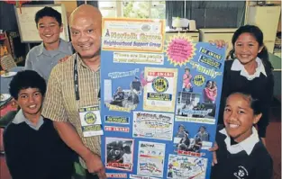  ??  ?? Feel safe: Mathew Samuela from the Cannons Creek Neighbourh­ood Policing Team with Holy Family School students, clockwise from bottom left, Lekuefa Liai, Thomas Tago, Ruby Ripley and Brigidine Miti and one of the JNS posters.