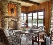  ?? COURTESY OF CARTER KAY INTERIORS ?? Wood, stone and a view of water and trees outside allow this indoor space from Carter Kay Interiors to embrace the outdoors.