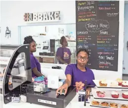  ??  ?? Tyra Bibbs, left, and Mallory Stephens work behind the counter at Jaybear Bake Shop in the Stage Coach Collection III shopping center. BRAD VEST / THE COMMERCIAL APPEAL