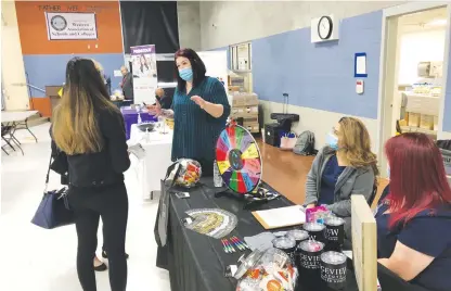  ?? David Wilson/appeal-democrat ?? Sonja Thomas with Bridgeview Post Acute talks with job seekers at the Yuba-sutter Job Fair in Yuba City on Thursday.