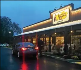  ?? PEG DEGRASSA – DIGITAL FIRST MEDIA ?? A car drops off a customer in the early-morning rainy darkness Monday morning at the Cracker Barrel Old Country Store in Ridley Township.
