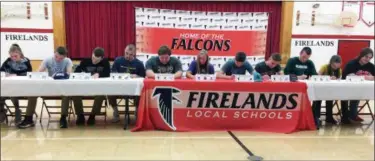  ?? FUAD SHALHOUT — THE MORNING JOURNAL ?? Athletes at Firelands High School sign their National Letters of Intent.