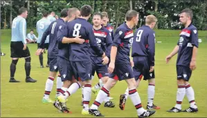  ??  ?? Craig MacEwan, No 8, is congratual­ated by his teammates after opening the scoring for Saints against
Alba Thistle at Glencruitt­en last Saturday