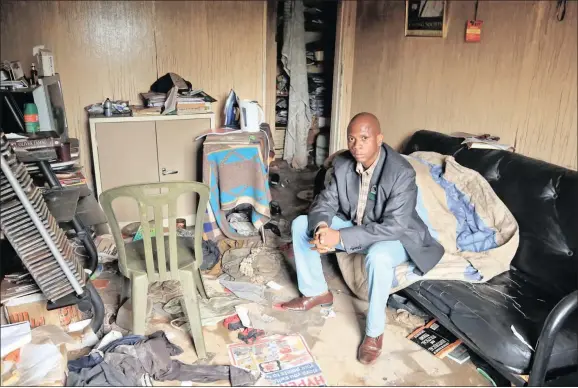  ??  ?? WAITING: Krisant Court resident Douglas Mthukwane in his flat that was damaged during the fire. He and other residents are waiting for repairs to start. Meanwhile, the Sol Plaatje Municipali­ty said it is just waiting for the insurance assessors to...