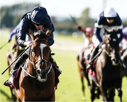  ?? ALAN CROWHURST/GETTY ?? Ryan Moore eases Flag Of Honour to victory from Latrobe in yesterday’s Irish St Leger at the Curragh