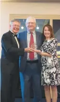  ?? ?? St. Coletta’s of Illinois Foundation Board Chairperso­n David Seaman of Tinley Park, left, and Foundation Board member Andrea Ramirez-Justin of Orland Hills present Beverly native William Waddell with St. Coletta’s 2022 Humanitas Award.