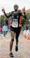  ?? Picture: FREDLIN ADRIAAN ?? FIRST HOME: Zolani Mabhongo crosses the line in 2:24:03 to win the 1City Marathon yesterday