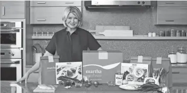  ?? Marcus Nilsson/Courtesy of Marley Spoon, Inc. via AP ?? In this photo provided by Marley Spoon, Inc., Martha Stewart poses with ingredient­s from a meal kit. Cooking like Stewart is about to get easier, as the home goods mogul and cookbook author is getting into the fast-growing meal kit business.