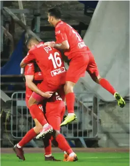  ?? (Ariel Shalom) ?? HAPOEL RA’ANANA players after their side’s second goal in a 2-1 victory over Beitar Jerusalem on Sunday night in Premier League action.