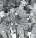  ?? FRANCK FIFE/GETTY ?? U.S. forward Christen Press, left, is excited after scoring a goal in the 10th minute Tuesday against England.