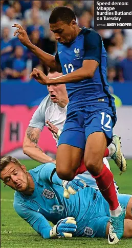  ?? ANDY HOOPER PICTURE: ?? Speed demon: Mbappe hurdles Butland on Tuesday