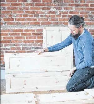  ?? THE CANADIAN PRESS/HO, JEREMY BURRILL ?? Jeremy Burrill works on building a casket in this undated handout photo. New Brunswick woodworker Jeremy Burrill has sold simple pine caskets locally for about two years, aiming to give people an affordable and more environmen­tally friendly option for...