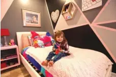  ?? TRACY HANES ?? NOW 3- year-old Addison’s room has a black, grey and pink colour-block pattern that’s feminine, while not overwhelmi­ngly pink.