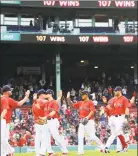  ?? Maddie Meyer / Getty Images ?? The Boston Red Sox celebrate their 107th win of the season, a 19-3 game against the Baltimore Orioles on Wednesday afternoon at Fenway Park.