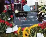  ??  ?? A plaque marking Chris Cornell's gravesite appears, covered in guitar picks, flowers, photos and notes.