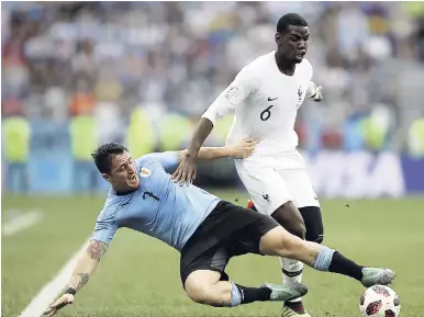  ?? AP ?? France’s Paul Pogba (right) clashes with Uruguay’s Cristian Rodriguez during the quarter-final match between Uruguay and France at the 2018 World Cup in the Nizhny Novgorod Stadium in Nizhny Novgorod, Russia, yesterday.