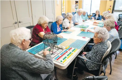  ??  ?? Seniors at Menno Place play bingo during an afternoon activity. Menno Place offers multiple care levels for seniors, and often sees couples entering the residence together, but receiving different levels of treatment and care.