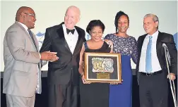  ??  ?? From left: Editor-In-Chief of The Gleaner, Garfield Grandison (left), congratula­tes The Jamaica Pegasus team – the hotel’s general manager, Peter Hillary; Prudence Simpson; Roxanne Williams; and Kevin Hendrickso­n.