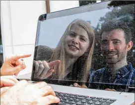  ?? JENNI GIRTMAN FOR THE ATLANTA JOURNAL-CONSTITUTI­ON ?? Graduate students Sarah Finch and James Finch look over code on James’ laptop last week outside. Emory University’s Mathematic­s and Science Center. The couple and their professor Jinho Choi led a team in creating Emora, an empathetic bot, for which they won a $500,000 Amazon prize. They continue to push technology boundaries while studying at Emory in Atlanta.