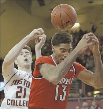  ?? AP PHOTO ?? AIR BALL: Louisville forward Ray Spalding, right, and Boston College forward Nik Popovic are unable to locate a loose rebound above their heads yesterday.