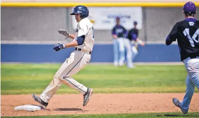  ?? MARLA BROSE/JOURNAL ?? La Cueva’s Bryce Richardson claps as he pulls into second base with a double during the first game of Saturday’s doublehead­er against Clovis. The host Bears won both games to secure the District 2-6A championsh­ip.