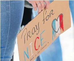  ?? EPA ?? People gather outside City Hall in San Francisco in tribute to the victims of the Nice truck attack. At least 84 people died and many were wounded on the famous Promenade des Anglais.