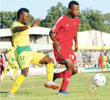  ??  ?? Peter Eneji (left) of Plateau United challenges Tope Olusesi of Rangers during a receny league game last season