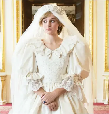  ??  ?? Crown jewel: Emma Corrin wears a detailed replica of the dress Princess Diana wore for her 1981 wedding.