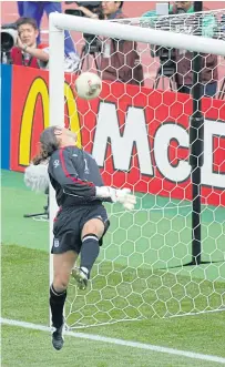  ??  ?? England goalkeeper David Seaman is beaten by Ronaldinho’s mis-hit at the 2002 World Cup. LEFT