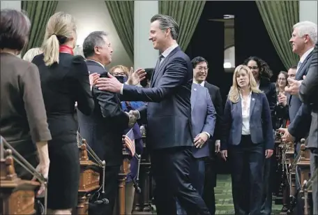  ?? Rich Pedroncell­i Associated Press ?? GOV. GAVIN NEWSOM shakes hands with Assemblyma­n Phil Ting (D-San Francisco) before giving his first State of the State address.