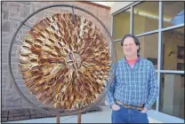  ?? COURTESY OF MARGARET MCKINNEY/NEW MEXICO HIGHLANDS UNIVERSITY ?? Fine arts professor David Lobdell stands with his cast-iron art piece “Binary Mandala.” Lobdell establishe­d Iron Tribe at Highlands in 2001.