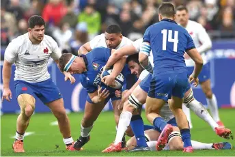  ??  ?? Italy’s flanker Giovanni Licata (second le ) is tackled by France’s prop Mohamed Haouas (centre) and France’s flanker Charles Ollivon (second right) during the Six Nations rugby union tournament match between France and Italy at the Stade de France in Saint-Denis, north of Paris.