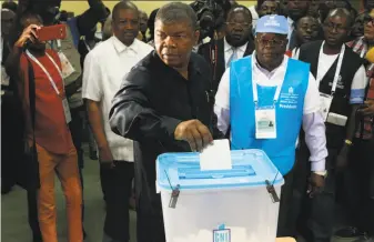  ?? Ampe Rogerio / AFP / Getty Images ?? Presidenti­al candidate Joao Lourenco casts his vote in Luanda. The election marks the end of President Jose Eduardo Dos Santos's 38-year reign, with his MPLA party set to retain power.