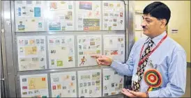  ?? DEEPAK GUPTA/ HT PHOTO ?? Dinesh Sharma with his Olympics philately collection at the Lalit Kala Akademi. (Below) Some of the stamps displayed as part of the collection.