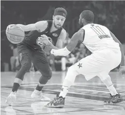  ?? KEVORK DJANSEZIAN/GETTY IMAGES ?? Stephen Curry of Team Stephen goes to make a move on Kyrie Irving of Team LeBron during Sunday night’s game in Los Angeles.